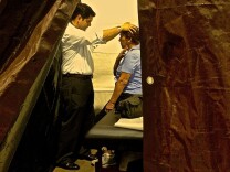 Rep. Raul Ruiz examines patient Mary Hernandez at a free medical clinic in Indio. It's the first time he's practiced medicine since going to Washington.