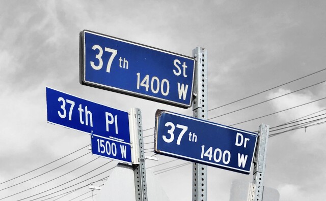 A collage of blue street signs for 37th Street, 37th Place, and 37th Drive. The background is a grayed out sky and power lines.