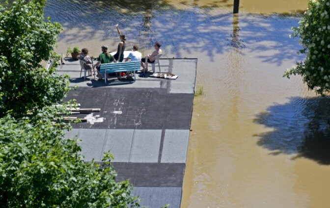 Residents sit on the roof of a garage flooded by the river Elbe in Dresden, eastern Germany, on June 5, 2013. Flooding has forced tens of thousands of evacuations across central Europe. (Photo by Robert Michael/AFP/Getty Images)