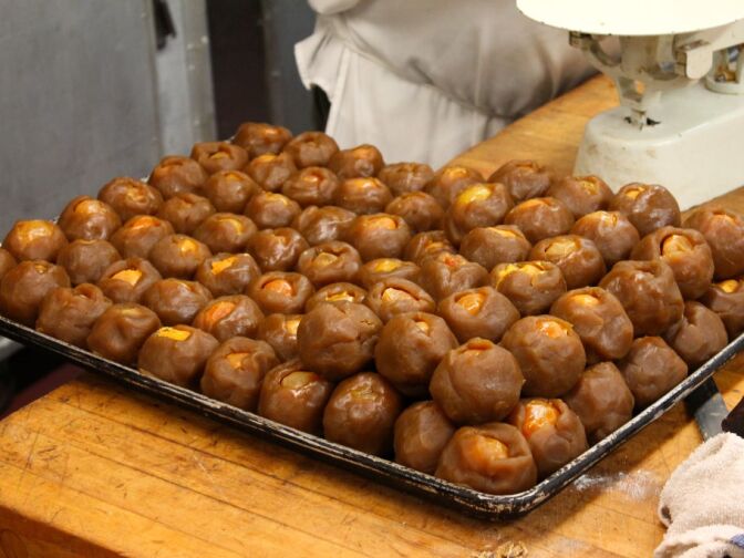 At Phoenix Bakery, yolks of duck eggs are placed inside balls of lotus bean paste. 