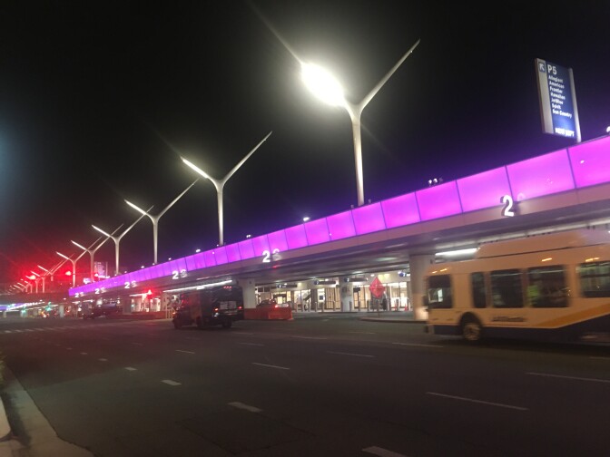 Lighted structures and the purple lighting strip shine from Terminal 2 before sunrise at LAX, Sept. 12, 2018