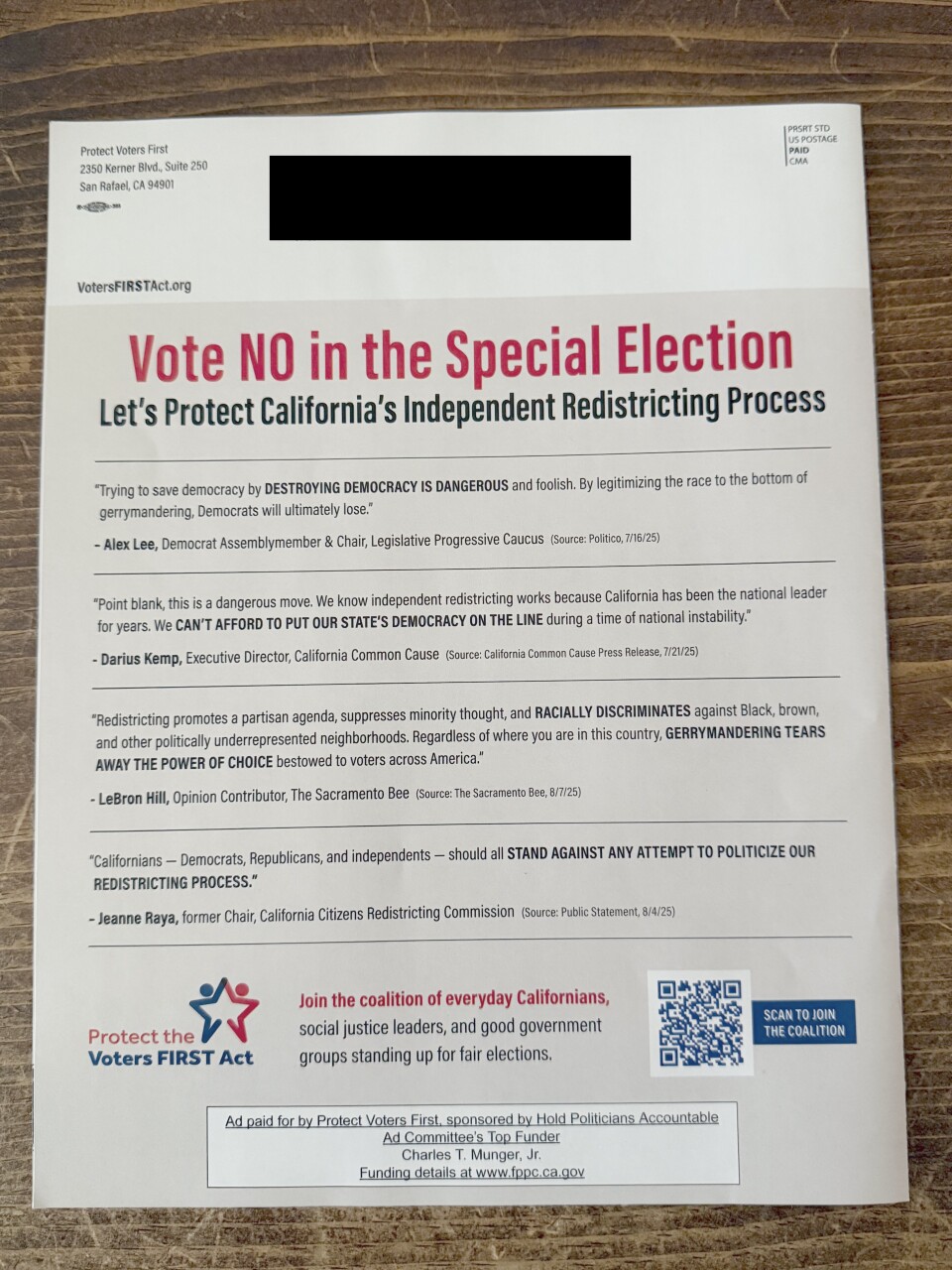 A white glossy mailer on a wood background. The top of the mailer reads: "Vote NO in the Special Election." 