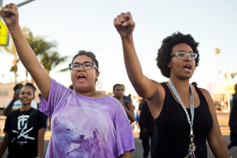 Velma Spencer, left, of Santa Monica and Jessica Williams of Monrovia take part in a march on Thursday evening, Aug. 14 for 25-year-old Ezell Ford who was fatally shot by Los Angeles police on Monday. The march began at West 65th Street where Ford was shot and travelled down South Broadway to LAPD's 77th Division.