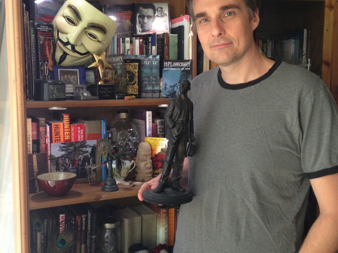 H.P. Lovecraft Film Festival organizer Aaron Vanek holding his "Howie" lifetime achievement award for contributions to Lovecraft cinema and culture. 
