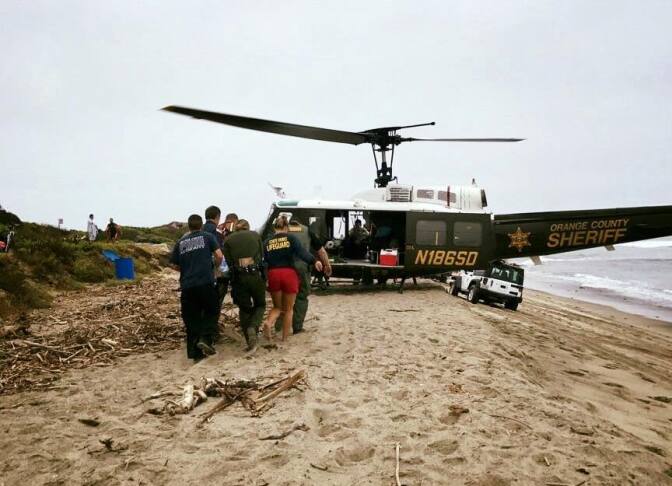 An Orange County Sheriff's Department helicopter rescues a surfer at Trestles Beach in San Clemente on Aug. 12, 2017. Cities that contract with OCSD for law enforcement say skyrocketing costs threaten their fiscal sustainability. 