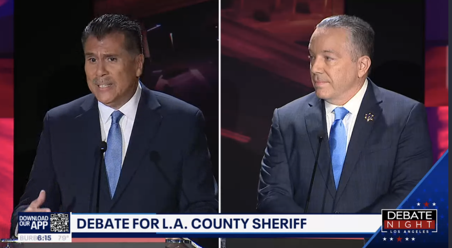 A split screen with two men in dark blue suits and ties on either side, chryron below them reads: Debate for L.A. County Sheriff