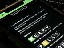 A close-up image of the game WORDLE on an iPhone screen. 