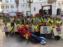 Officials and Holmes Avenue Elementary students pose with Rocket in front of City Hall before the Great ShakeOut earthquake drill.