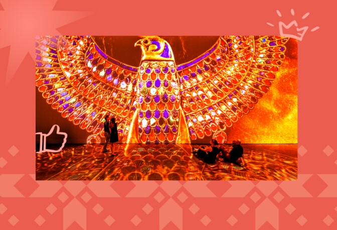 A group of people, two standing and two sitting, in front of a projection of an Egyptian artifact.