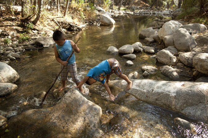Angel Torres, 7, and his brother, Kevin, 6, play in a river in the San Gabriel Mountains. President Obama designated part of the area in the Los Angeles National Forest a national monument.