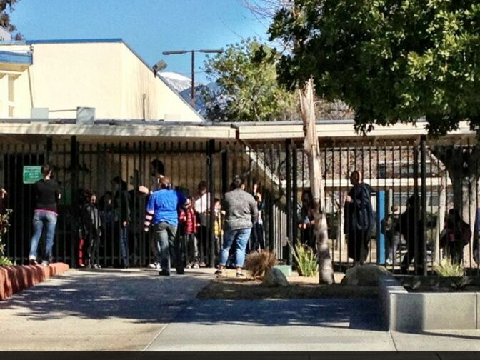This is a photo from Thomas R. Cordova, who describes himself as a staff photographer at the Inland Valley Daily Bulletin, showing parents picking up their children after schools in the Big Bear area were locked down on Feb. 12, 2013. Police enegaged in fire gun battles in the area with someone they believe to be Christopher Dorner.