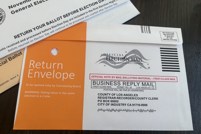 A ballot return envelope addressed to the LA County Registrar-Recorder, marked 'Official Election Mail' with no postage required.