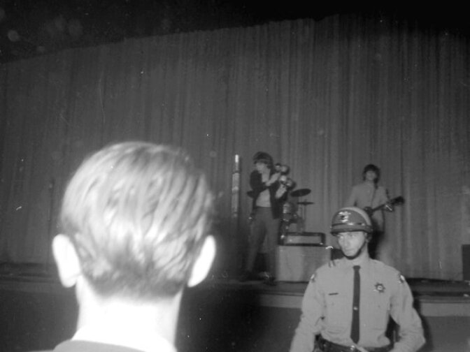 Mick Jagger shakes maracas in the background at a Rolling Stones show at the Swing Auditorium in San Bernardino.