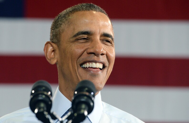 US President Barack Obama smiles as he speaks at the Costco in Lanham, Maryland, on January 29, 2014 to highlight the importance of raising the federal minimum wage for all Americans.