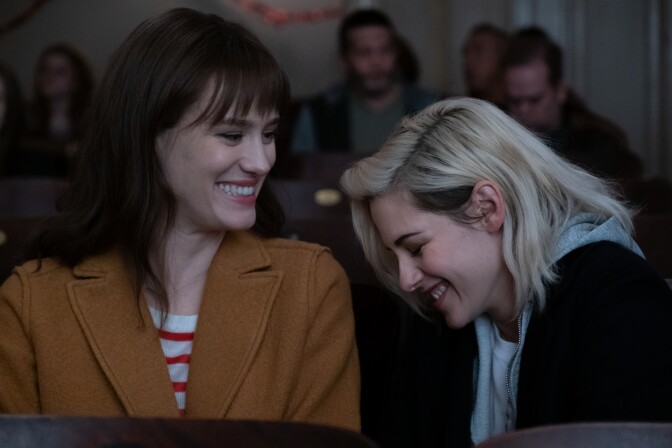 Abby (Kristen Stewart) and Harper (Mackenzie Davis) enjoy a moment at the movies in TriStar Pictures' romantic comedy "Happiest Season."