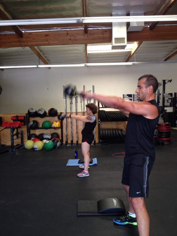 Alex Cohen and A Martinez do a CrossFit workout. 