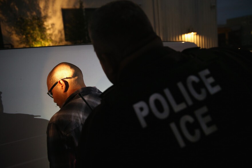 NORTHRIDGE, CA - OCTOBER 14:  A man is detained by Immigration and Customs Enforcement (ICE), agents early on October 14, 2015 in Los Angeles, California. ICE agents said the undocumented immigrant was a convicted criminal and gang member who had previously been deported to Mexico and would be again. ICE builds deportation cases against thousands of undocumented immigrants, most of whom, they say, have criminal records. The number of ICE detentions and deportations from California has dropped since the state passed the Trust Act in October 2013, which set limits on California law enforcement cooperation with federal immigration authorities.  (Photo by John Moore/Getty Images)