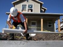 A worker cuts a piece of pipe as he builds a new home in January 2015 in Petaluma, Calif. Construction jobs had a strong 2015 in California.