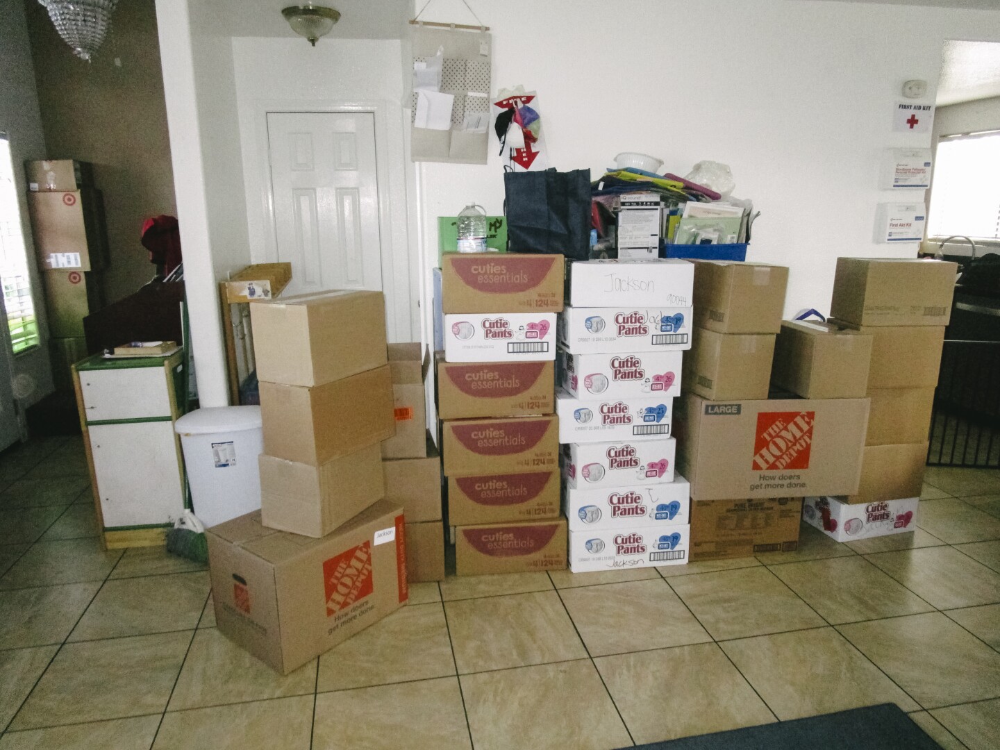In this image, boxes are shown stacked up against a wall.