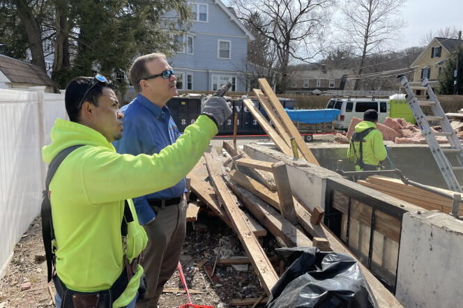 Builder Emerson Claus and his foreman Rene Landeverde at the site of an apartment they are building in a suburb of Boston.