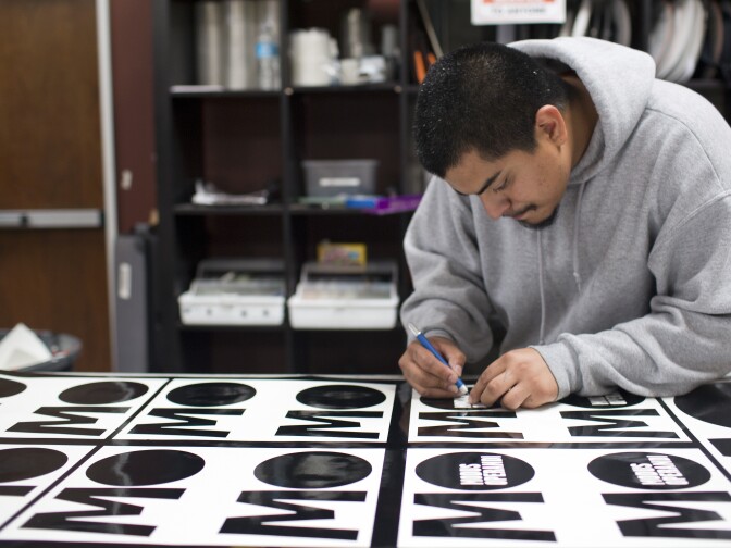 Sign maker Mike Medrano estimates he makes 80 to 100 yellow directional signs for film sets each day.