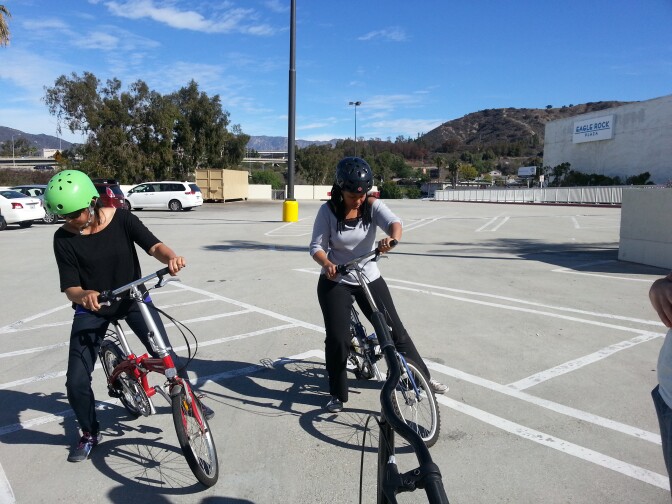 Sherene Hulugalle, left and classmate Saudeka Shabazz practicing “leans” during CICLE's "Learn to Ride for Adults" bicycling class.