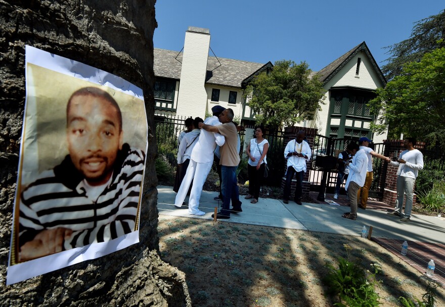 Members of the 'Black Lives Matter' alliance stage a protest outside the residence of Los Angeles Mayor Eric Garcetti  as they try to force him to fire LAPD Police Chief Charlie Beck, in Los Angeles, California on June 7, 2015. The alliance have renewed protests after a recent report from an LAPD watchdog determined that the August 11, 2014 officer-involved shooting death of 25-year-old Ezell Ford in South Central was justified.        AFP PHOTO / MARK RALSTON        (Photo credit should read MARK RALSTON/AFP/Getty Images)