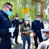 Facemasks remain worn as firefighter paramedic Jorge Miranda, holding syringe, speaks with Eduardo Vasquez, who has lived homeless on the streets of Los Angeles since 1992, before administering the one-shot Johnson and Johnson' Janssen Covid-19 vaccine as part of outreach to the homeless by members of the Los Angeles Fire Department's Covid Outreach unit on June 14, 2021 in Los Angeles - With more than 40 million vaccine doses administered, California is one of the last state's to fully reopen its economy, though businesses have been open at reduced capacity for months. (Photo by Frederic J. BROWN / AFP) (Photo by FREDERIC J. BROWN/AFP via Getty Images)