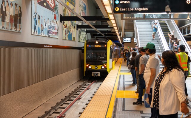 A subway train going to Azusa arrives at a station