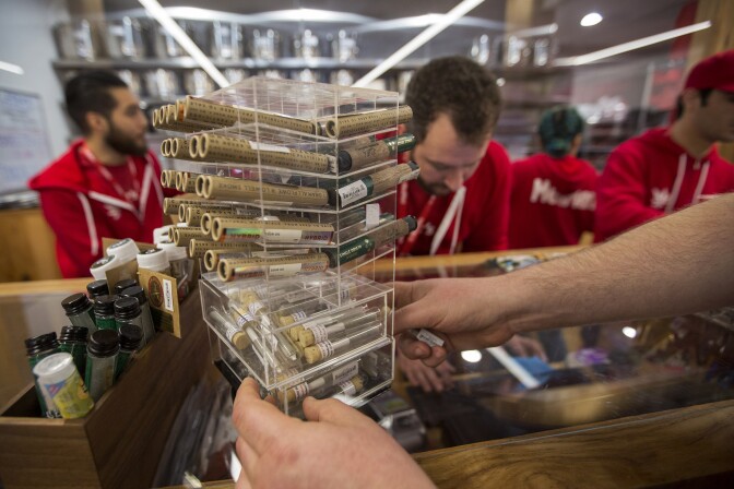 WEST HOLLYWOOD, CA - JANUARY 02: A customer reaches for cannabis products at MedMen, one of the two Los Angeles area pot shops that began selling marijuana for recreational use under the new California marijuana law today, on January 2, 2018 in West Hollywood, California. Los Angeles and other nearby cities outside of West Hollywood have not finalized their local permitting rules so licenses to businesses in those jurisdictions are yet to be granted.  (Photo by David McNew/Getty Images)