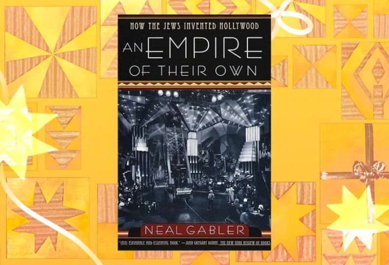A photograph of a book cover entitled, "An Empire of Their Own." Beneath the black-and-white art deco font, there is a photograph of a movie set that is busy with people doing their jobs. The book cover is positioned against a festive gold background featuring holiday stars, gift boxes and strands of ribbon.