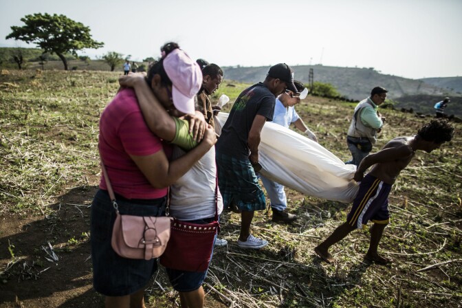 A daughter embraces her mother after relatives of Alberto Hernández retrieve his body, in a rural area near Caserío el Chumpe, El Salvador. Police believe that the 42-year-old made his living as a driver and was kidnapped and killed by gang members. His body was discovered at a clandestine grave site by family members who spotted vultures circling overhead. (AP Photo/Manu Brabo)
