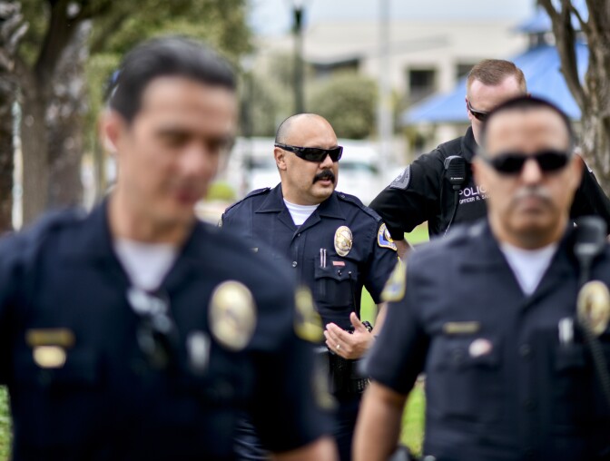 Anaheim Community Policing Team Officer Jesse Romero, center, walks with colleagues in the Guinida Lane neighborhood in Anaheim Thursday. 

Anaheim Police Department CPT division on patrol in Anaheim Thursday January 29th, 2014. The CPT division engages communities to reduce crime and build relationships with citizens to improve the community.Anaheim Police Department CPT division on patrol in Anaheim Thursday January 29th, 2014. The CPT division engages communities to reduce crime and build relationships with citizens to improve the community. 

