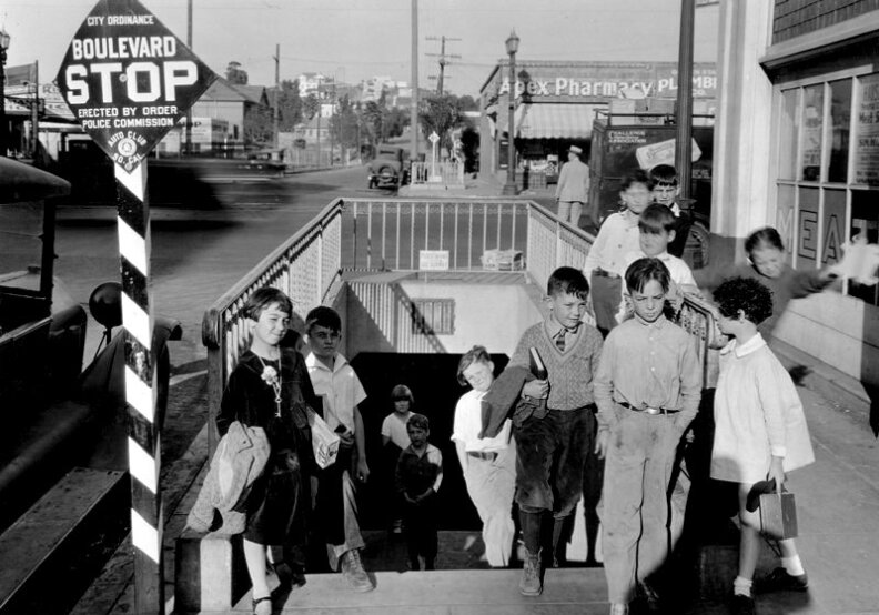 From Dec. 6, 1927: "School tunnel at Sunset Boulevard and Logan Street, south entrance. Apex Pharmacy is in the background along with a Challenge Cream and Butter Association Truck."