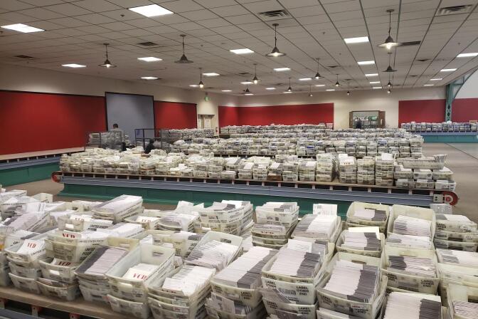Scores of mail bins full of unopened mail-in ballots