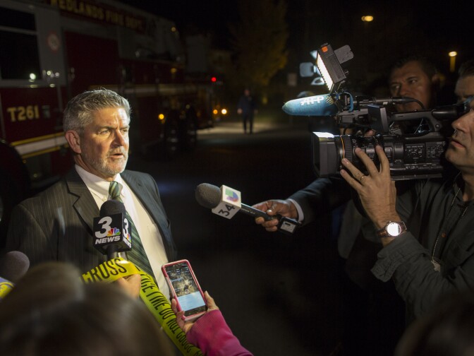 Carl Baker of the City of Redlands speaks to media near Center Street and Pine Avenue on Wednesday night, Dec. 2, 2015 as authorities serve a search warrant following a mass shooting inside the the Inland Regional Center in San Bernardino on Wednesday, Dec. 2, 2015.