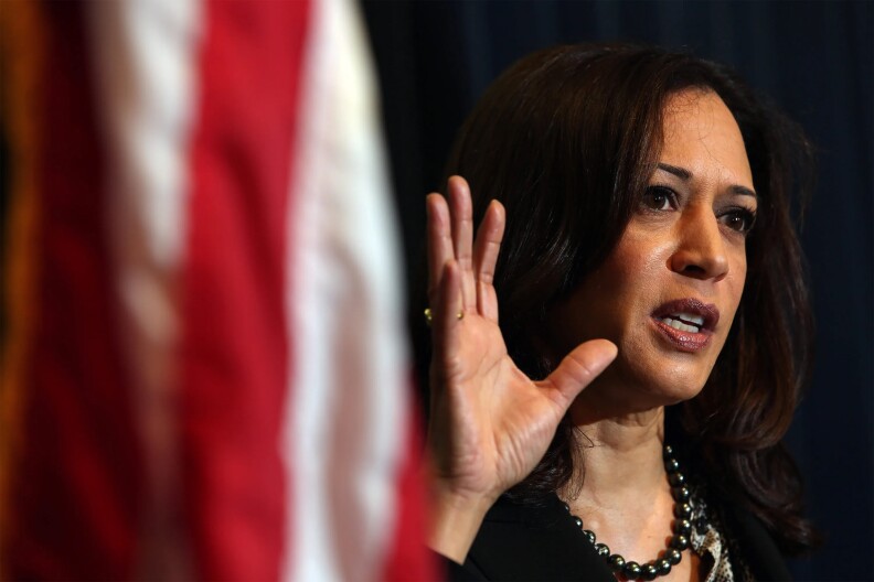 Red and white stripes hang down the left-side frame. Facing the other way, a female-presenting person holds her hand up in mid-speech.