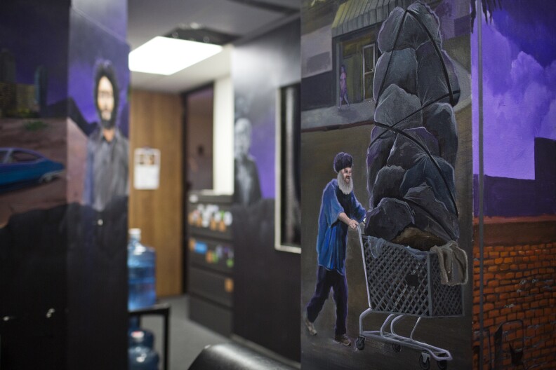 Paintings of famous Los Angeles landmarks and characters fill the walls of Skidrow Studios in the Financial District, including paintings depicting Skid Row.