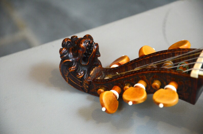A carved lion head on an original, 18th-century bass viola da gamba made in Sweden, patterned after an English viol.