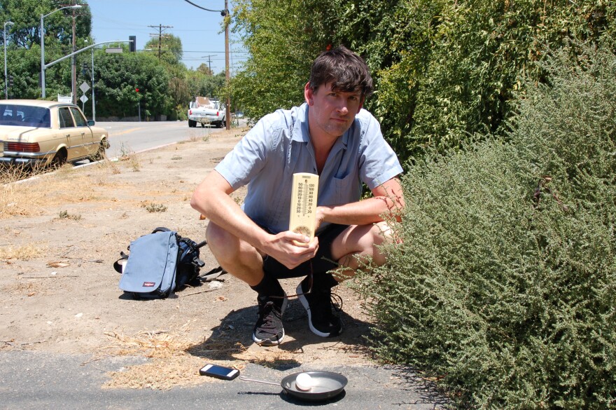 KPCC's John Rabe in Sherwood Forest preparing to fry an egg on the sidewalk.