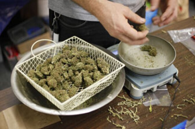 A worker at the San Francisco Medical Cannabis Clinic prepares packets of marijuana buds for sale in San Francisco, Monday, Oct. 19, 2009.