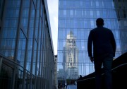 A guest arrives for a reception celebrating Latino Heritage Month as Los Angeles City Hall is reflected on the glass facade of the LAPD headquarters on Thursday, Sept. 18, 2014, in Los Angeles. (AP Photo/Jae C. Hong)