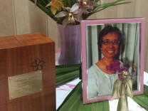 A photo behind a silver angel statue adorns a table at the memorial for preschool teacher, Ginny Zywot, who died of cancer on Dec 21, 2014. Her family, friends and preschool families gathered on Saturday February 28, 2015, to celebrate her life. 