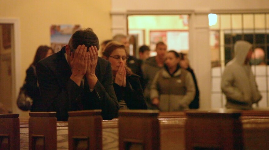 Residents of Newtown, Connecticut pray for the victims of the shooting at Sandy Hook Elementary School.