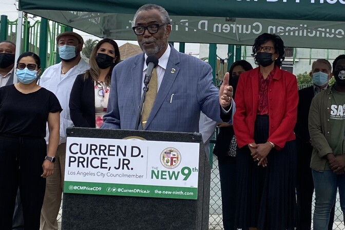 L.A. City Councilmember Curren Price stands at a podium as he speaks to press to announce a motion that would set up a $5 million relief fund for families affected by the June 30 botched LAPD detonation. 