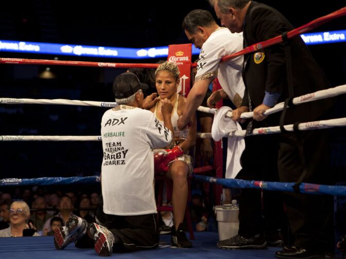"La Barbie" sits in her corner, attended by her U.S. trainer Ben Lira.
