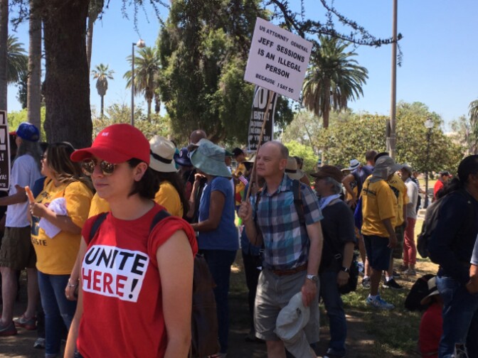 A marcher holds up a sign during May Day 2017.