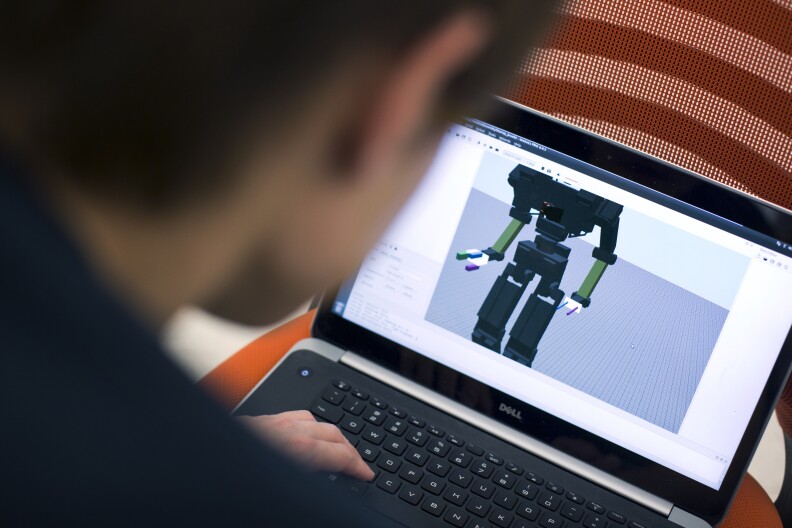 Min Sung Ahn works with THOR through a laptop on Friday, May 8, 2015 inside UCLA's Robotics and Mechanisms Laboratory. Though the team has been working on the robot for years, it struggles with daily tasks like getting in and out of cars.