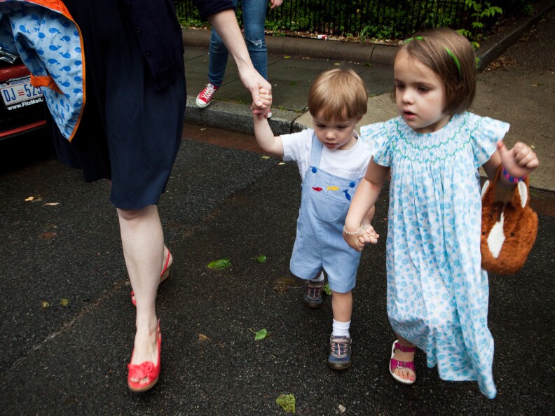 Eaddy Holmes, 4, holds her brother's hand as they cross the street. Sometimes she can't sleep because she worries he will have a seizure.