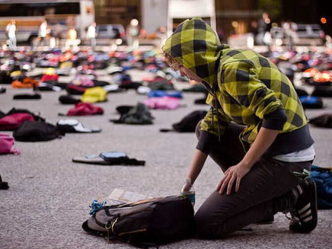 A student approaches a backpack that is part of a Send Silence Packing exhibit. The project is currently touring around the Southland.